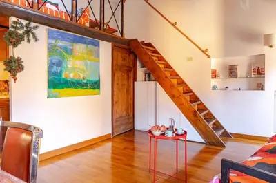 a living room with a staircase and a table at Loft Colosseo, in Rome Center in Rome