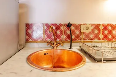 a copper sink in a bathroom with a rack at Loft Colosseo, in Rome Center in Rome
