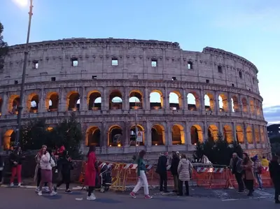 a group of people standing in front of the coliseum at Loft Colosseo, in Rome Center in Rome