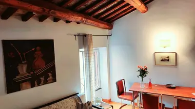 a dining room with a table and a painting on the wall at Loft Colosseo, in Rome Center in Rome