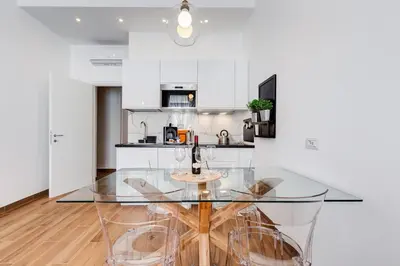 a kitchen with a glass table and chairs at Roma in relax lovely two room in the center of Rome, Fabrizia in Rome