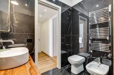 a bathroom with a white sink and a toilet at Roma in relax lovely two room in the center of Rome, Fabrizia in Rome