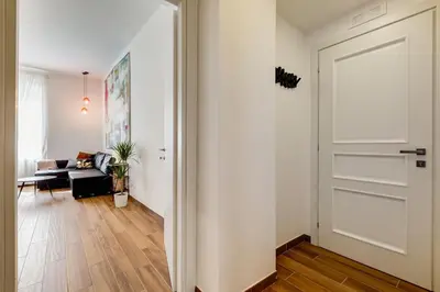 a hallway with a white door and a living room at Roma in relax lovely two room in the center of Rome, Fabrizia in Rome