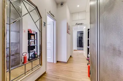 a hallway with a large glass window and a hallway with a hallway at Roma in relax lovely two room in the center of Rome, Fabrizia in Rome