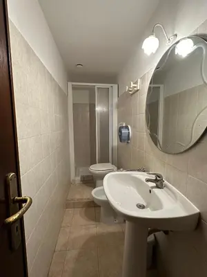 a bathroom with a sink and a toilet and a mirror at Alloggio Turistico in Rome