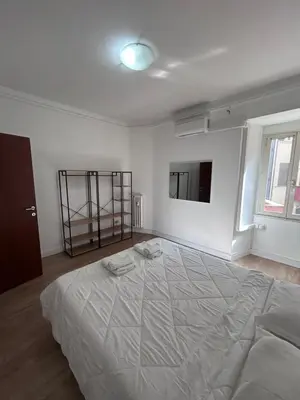 a bedroom with a large bed with two towels on it at Ragusa Holiday Home in Rome