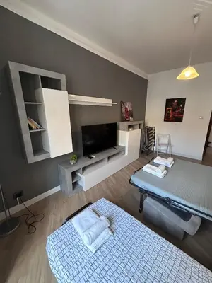 a living room with a couch and a tv at Ragusa Holiday Home in Rome