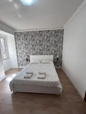 a bedroom with a bed with two towels on it at Ragusa Holiday Home in Rome