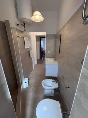 a bathroom with a toilet and a sink at Ragusa Holiday Home in Rome