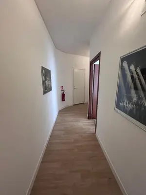 a hallway with two pictures on the walls and a hallwayngthngthngthngthngth at Ragusa Holiday Home in Rome