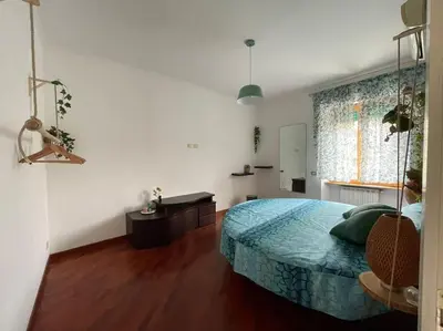 a bedroom with a large bed and a window at La Casetta Azzurra in Rome