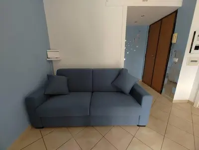 a blue couch sitting in a living room at La Casetta Azzurra in Rome