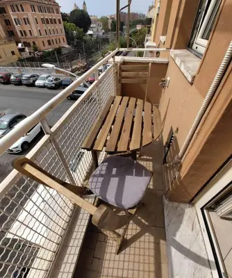 a wooden bench sitting on the balcony of a building at La Casetta Azzurra in Rome
