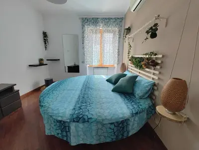 a bedroom with a large blue bed in a room at La Casetta Azzurra in Rome