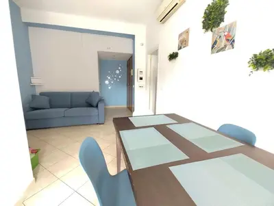 a living room with a table and chairs and a couch at La Casetta Azzurra in Rome