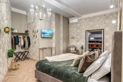 a bedroom with a large bed and a chandelier at White Miracle Suite in Rome