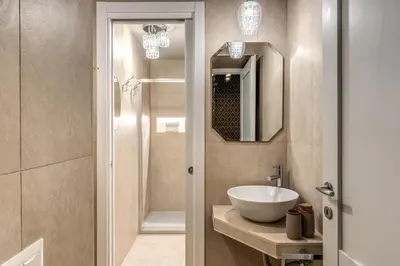 a bathroom with a sink and a mirror at White Miracle Suite in Rome