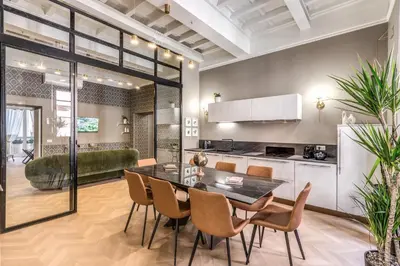 a kitchen and dining room with a table and chairs at White Miracle Suite in Rome