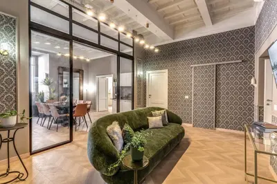 a living room with a green couch and a table at White Miracle Suite in Rome