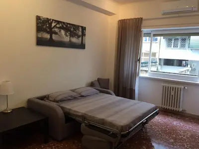 a bedroom with a bed and a window at Romolo House in Rome