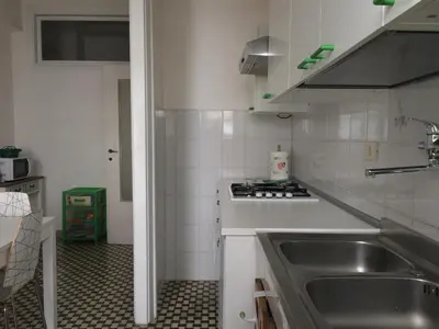 a small kitchen with a sink and a stove at Romolo House in Rome