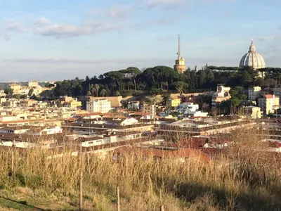 a view of a city from a hill with buildings at Romolo House in Rome