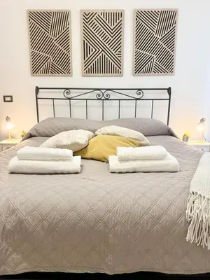 a bedroom with a bed with two pillows on it at Voluptas house Trastevere Testaccio in Rome