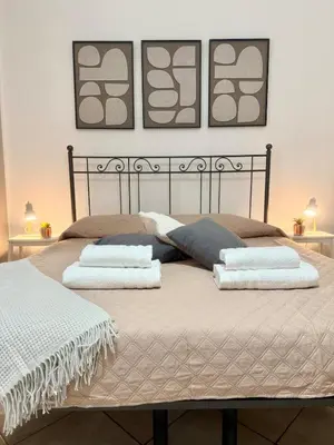 a bedroom with a bed with two pillows on it at Voluptas house Trastevere Testaccio in Rome