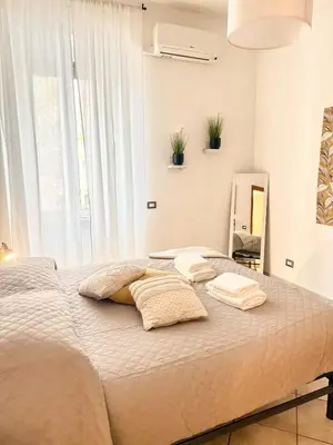 a bedroom with a large bed with towels on it at Voluptas house Trastevere Testaccio in Rome
