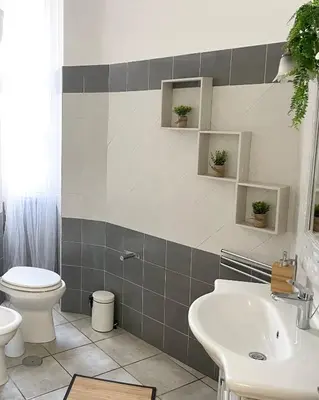 a bathroom with a toilet and a sink at Voluptas house Trastevere Testaccio in Rome