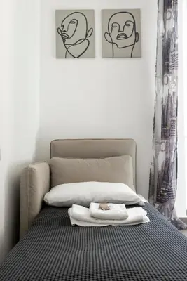 a bedroom with a bed with towels on it at Maison del Re - San Giovanni by RHR in Rome