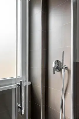 a shower with a shower head in a bathroom at Maison del Re - San Giovanni by RHR in Rome