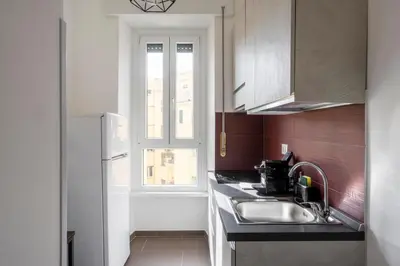 a kitchen with a sink and a window at Maison del Re - San Giovanni by RHR in Rome