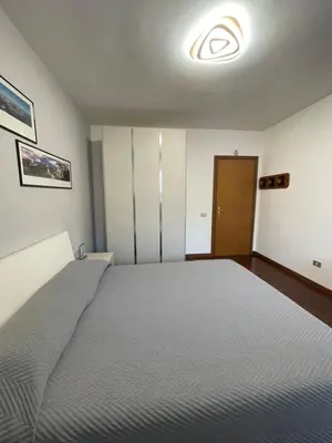 a bedroom with a large bed in a room at Stanza Eur Tintoretto in Rome