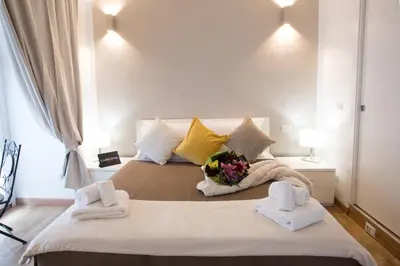 a bedroom with a large bed with towels and flowers on it at Chroma Italy - Chroma Octho in Rome