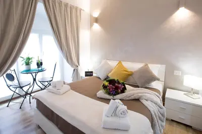 a bedroom with a large bed with towels on it at Chroma Italy - Chroma Octho in Rome