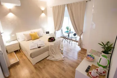 a small bedroom with a bed and a table at Chroma Italy - Chroma Octho in Rome