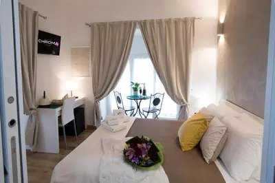 a bedroom with a bed with a bowl of flowers on it at Chroma Italy - Chroma Octho in Rome