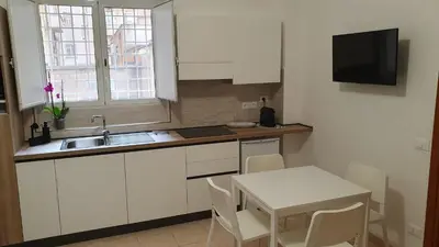 a kitchen with a sink and a table with chairs at Melory House in Rome