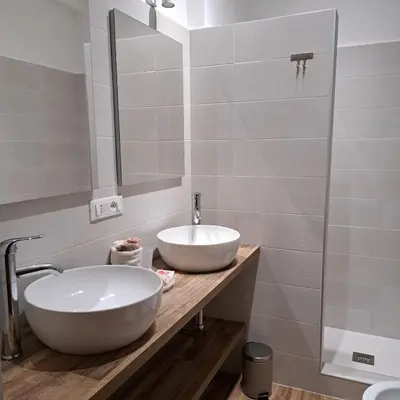 a bathroom with a white sink and a mirror at Melory House in Rome