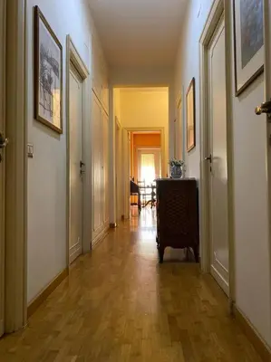 a hallway with a room with a table and some doors at Joyful Home in Rome