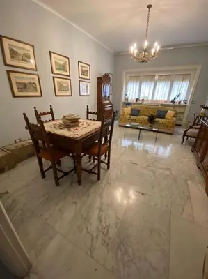 a living room with a table and chairs and a couch at Joyful Home in Rome