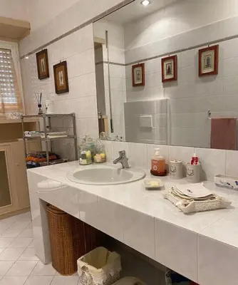 a bathroom with a sink and a mirror at Joyful Home in Rome
