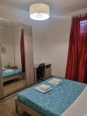 a bedroom with a mirror and a bed with towels at Ad un passo dal Vaticano in Rome