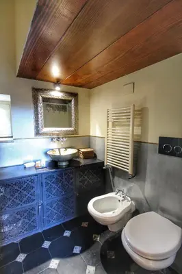 a bathroom with a toilet and a sink at Trastevere Charming Romantic Loft By YourHost in Rome