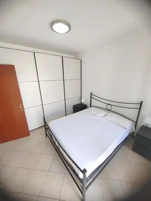 a bedroom with a bed with a metal frame at Casa Aurelia in Rome