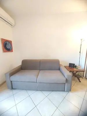 a couch in a living room with a table at Casa Aurelia in Rome