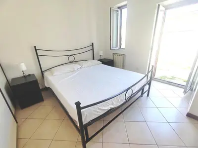 a bedroom with a bed and a large window at Casa Aurelia in Rome