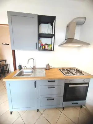 a kitchen with a sink and a stove top oven at Casa Aurelia in Rome