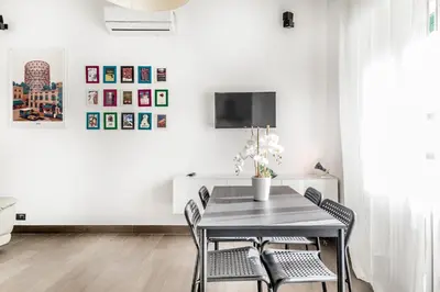 a dining room with a table and chairs at BBHOME Tiburtina Station apartment in Rome